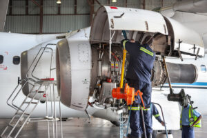 Man working on inside of a jet engine